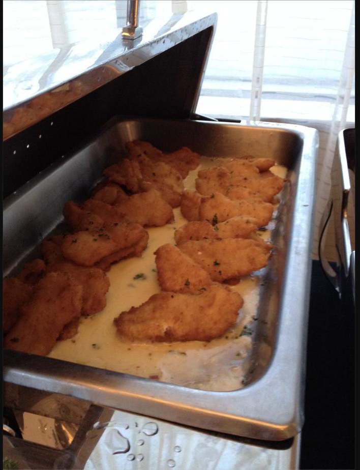 Breaded, fried lionfish fillets in a warm lemon-butter sauce